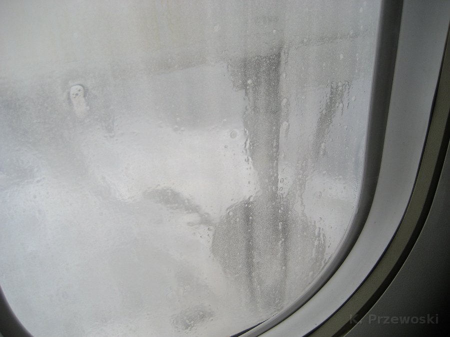 IMG_0506.JPG - Przed startem oblano samolot środkiem odmarzającym. Miałem tylko nadzieję, że po starcie pęd powietrza wyczyści mi trochę okienko do następnych zdjęć